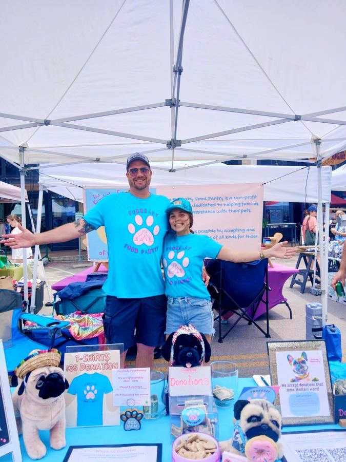 Volunteers at a pantry event tent with donated supplies