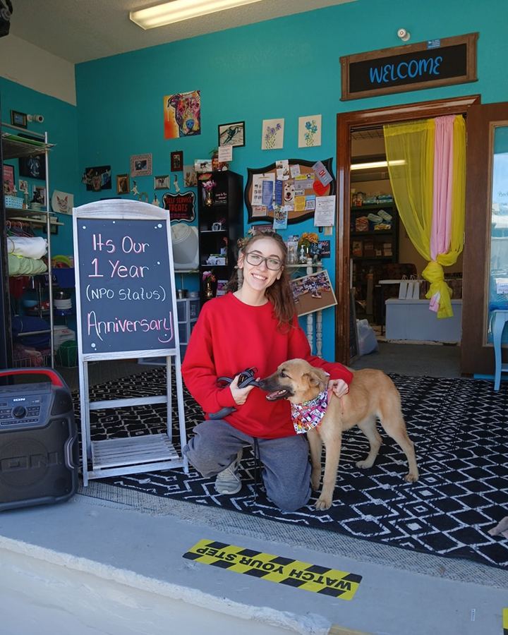 A pantry guest visiting with their dog inside the pantry